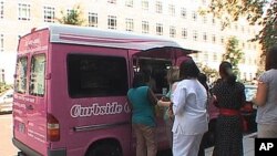 Customers line up to buy cupcakes after being alerted to the truck's arrival via Facebook and Twitter.