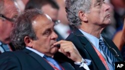 FILE - FIFA vice president Angel Maria Villar Llona (right) and UEFA President Michel Platini attend the preliminary draw for the 2018 soccer World Cup in Konstantin Palace in St. Petersburg, Russia, July 25, 2015.