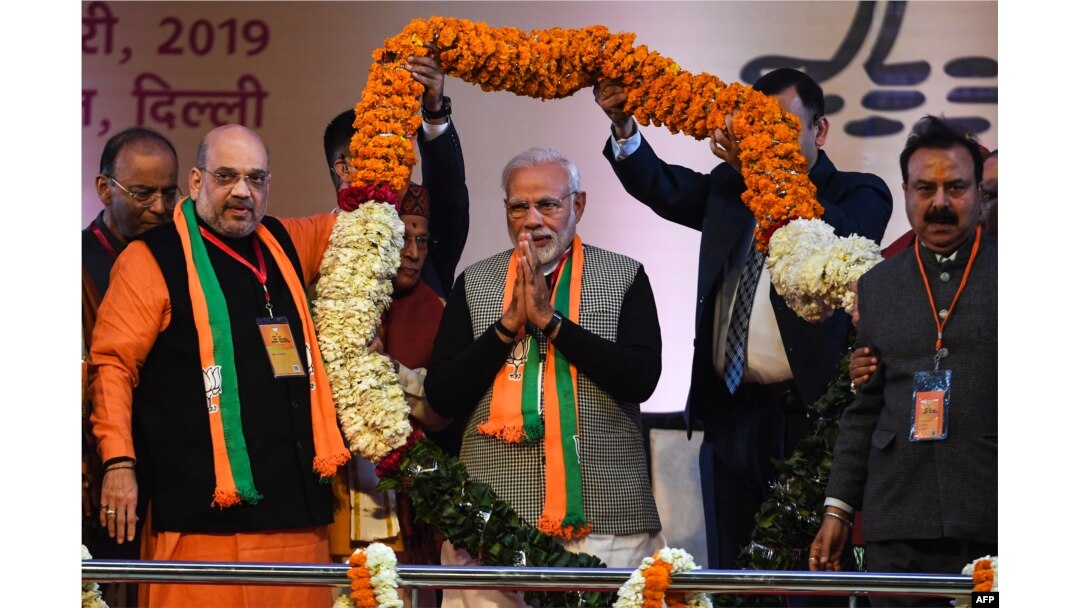 FILE - Indian Prime Minister Narendra Modi, center, is garlanded by BJP leaders on the first day of the two-day Bharatiya Janata Party national convention in New Delhi, Jan. 11, 2019.