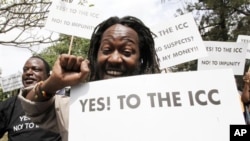 Kenyan protesters hold placards while shouting slogans during a protest in Nairobi, Jan 18 2011