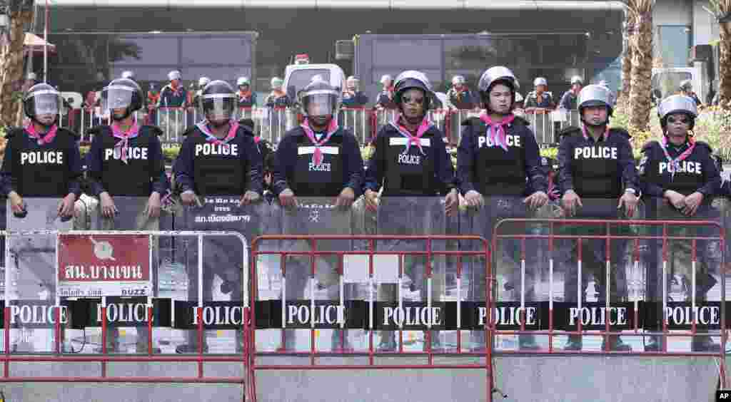 Riot policemen stand guard at Constitutional court in Bangkok. Thailand&#39;s beleaguered government, plagued by street protests over an ill-advised attempt to help ousted former Prime Minister Thaksin Shinawatra, faces a fresh challenge Wednesday when a court rules on its attempt to amend the constitution.