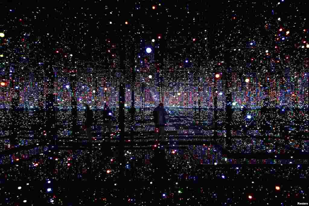 A photographer takes pictures of an installation titled &quot;Infinity Mirrored Room - Filled With the Brilliance of Life&quot; by Japanese artist Yayoi Kusama during her exhibition at the Rufino Tamayo museum in Mexico City, Mexico.