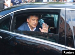 Former Turkish President Abdullah Gul waves as he leaves a memorial service for the victims of the thwarted coup in Istanbul, July 17, 2016.
