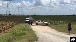 Police cars block access to the site where a hot air balloon crashed near Lockhart, Texas, July 30, 2016. At least 16 people were on board the balloon, which a Federal Aviation Administration spokesman said caught fire before crashing into a pasture.