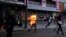 A man who was set on fire by people accusing him of stealing during a rally against President Nicolas Maduro runs amidst opposition supporters in Caracas, Venezuela, May 20, 2017. 