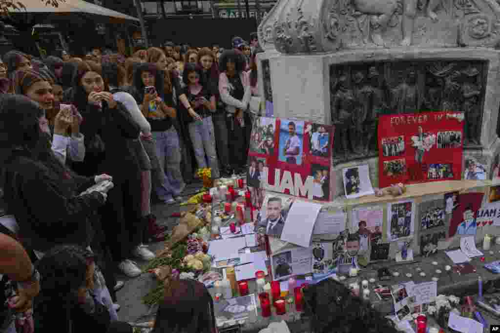 Fans of former One Direction singer Liam Payne gather to honor him in Madrid, Spain, after the British pop singer fell to his death from a hotel balcony in Buenos Aires, Argentina.