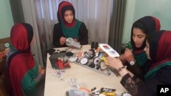 Teenagers from the Afghanistan Robotic House, a private training institute, practice recently at the Better Idea Organization center, in Herat, Afghanistan. Six female students from war-torn Afghanistan were given permission to participate in an international robotics competition in Washington D.C -- after being turned down twice for visas. AP Photos/Ahmad Seir)