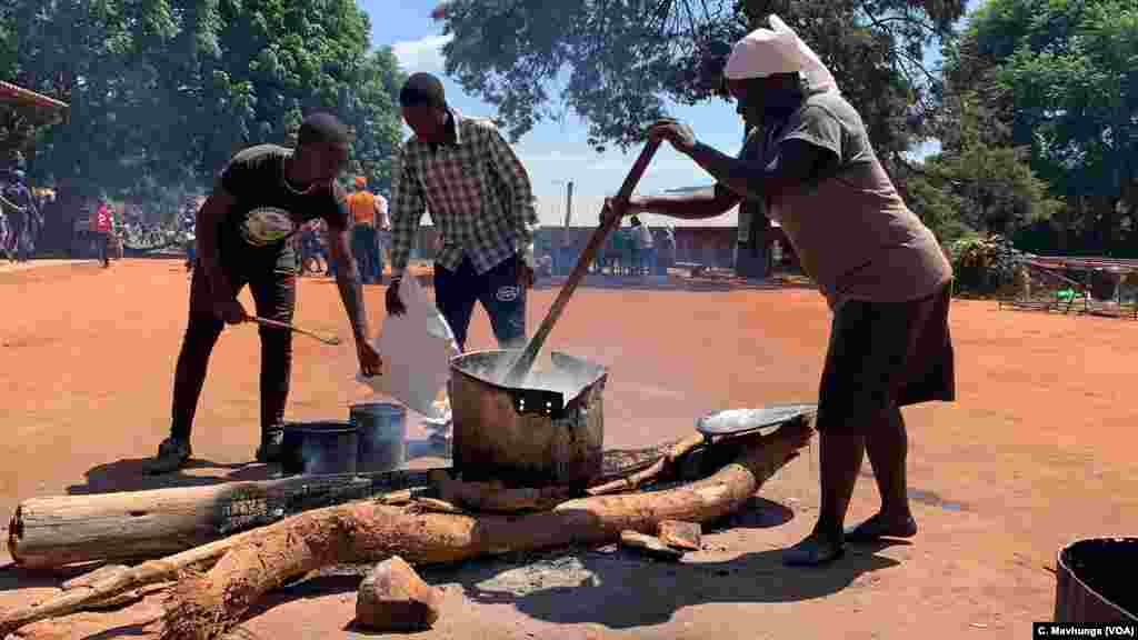 Volunteers prepare a meal March 26, 2019, for children at Ngangu Primary School in Chimanimani, which is being used to help children cope with Cyclone Idai trauma they may have experienced.