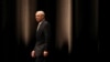 Former U.S. Secretary of State Colin Powell walks in the stage to speak during a seminar in Tokyo, June 18, 2014