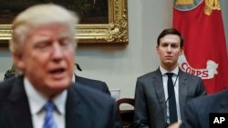 FILE - White House Senior Adviser Jared Kushner, right, listens to President Donald Trump speak during a breakfast with business leaders in the Roosevelt Room of the White House in Washington. 