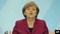 German Chancellor Angela Merkel speaks during a news conference in the Chancellery in Berlin, March 15, 2011