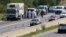 Police stand near a truck stopped on the side of the highway near Parndorf south of Vienna, Austria, Aug 27, 2015. Officials say up to 50 migrants were found dead in the truck. They reportedly suffocated.