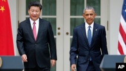 FILE - President Barack Obama and Chinese President Xi Jinping arrive for their joint new conference, Sept 25, 2015.