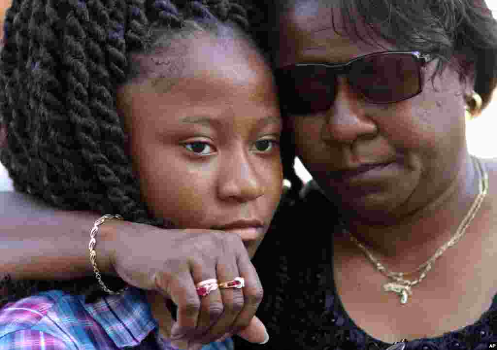 Antonee Martin, left, and her mother Latrechia Jackson, right, visit the memorial site set up in front of the Emanuel AME Church, June 18, 2015 in Charleston, S.C.