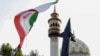 Iranians lift up a flag and the mock-up of a missile during a celebration following Iran's missiles and drones attack on Israel, on April 15 2024, at Palestine square in central Tehran.