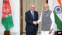 Afghan President Ashraf Ghani, left, and Indian Prime Minister Narendra Modi shake hands before the start of their official meeting in New Delhi, Oct. 24, 2017.