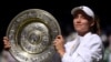 FILE: At Wimbledon, Kazakhstan's Elena Rybakina poses with the trophy after winning the women's singles final against Tunisia's Ons Jabeur, the first African woman to reach the storied tournament's finals. 7.9.2022