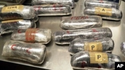 FILE - This photo provided by U.S. Customs and Border Protection shows packages of methamphetamine and heroin found in a car at the U.S.-Mexico border port of entry in Nogales, Ariz. Border Patrol agents seized more than $1 million in heroin Friday in New