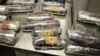 (FILE) This photo provided by U.S. Customs and Border Protection shows 16 packages of methamphetamine and heroin found in a car at the U.S.-Mexico border port of entry in Nogales, Ariz on June 10, 2015.