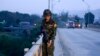An army-linked militiaman secures a bridge in Muse, Myanmar, May 12, 2018.