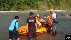 In this photo released by the Disaster Mitigation Agency of Bengkulu Province's Kaur District, rescue team prepares to search for victims of bridge break, Jan. 20, 2020. 