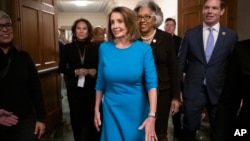 House Democratic Leader Nancy Pelosi of California, joined at by Rep. Joyce Beatty, D-Ohio, and Rep. Eric Swalwell, D-Calif., emerges victorious from the Democratic Caucus leadership elections at the Capitol in Washington, Nov. 28, 2018.