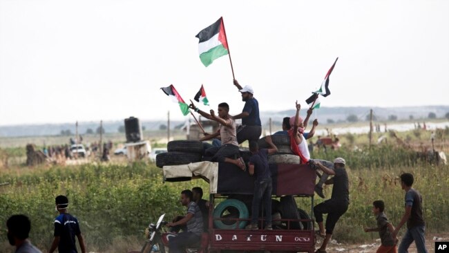 巴勒斯坦人向在以色列边界的示威者运送焚烧用的轮胎 （2018年8月3日）