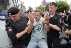 FILE - Police detain Russian opposition leader Alexey Navalny during a rally in Moscow, Russia, June 12, 2019.