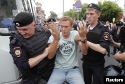 FILE - Police detain Russian opposition leader Alexey Navalny during a rally in Moscow, Russia, June 12, 2019.
