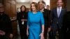 House Democratic Leader Nancy Pelosi of California, joined at by Rep. Joyce Beatty, D-Ohio, and Rep. Eric Swalwell, D-Calif., emerges victorious from the Democratic Caucus leadership elections at the Capitol in Washington, Nov. 28, 2018.