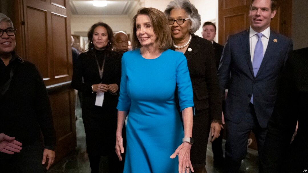 House Democratic Leader Nancy Pelosi of California, joined at by Rep. Joyce Beatty, D-Ohio, and Rep. Eric Swalwell, D-Calif., emerges victorious from the Democratic Caucus leadership elections at the Capitol in Washington, Nov. 28, 2018.