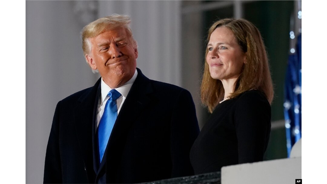 President Donald Trump and Amy Coney Barrett stand on the Blue Room Balcony after Supreme Court Justice Clarence Thomas administered the Constitutional Oath on Oct. 26, 2020.