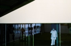 A health worker speaks on the mobile phone inside Hospital del Mar, after Catalonia's government imposed new restrictions in an effort to control a new outbreak of the coronavirus disease, in Barcelona, Spain, Oct. 20, 2020. (Reuters)