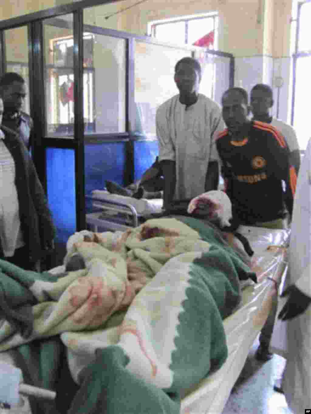 A victim of Friday's bomb blast and gun attacks is transported in Murtala Muhammad specialist hospital in Kano, Nigeria Saturday, Jan. 21, 2012.