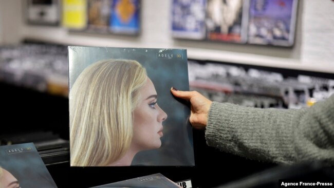 A member of staff sorts copies of the new album from British singer-songwriter Adele,