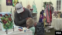 Shoppers examine goods made by refugees in the pop-up shop in Phoenix, Arizona..