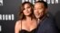 FILE - John Legend, executive producer of "Underground," poses with his wife Chrissy Teigen at the season two premiere of the television series.