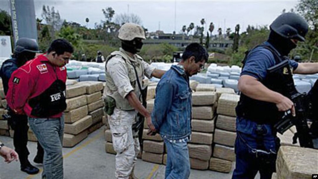 Soldiers and police officers escort detainees after a conjoined operation with the army, local and state police seized 105 tons of U.S.-bound marijuana in Tijuana, Mexico, 18 Oct 2010