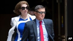 FILE - Former national security adviser Michael Flynn, right, and his lawyer, Sidney Powell, leaves the federal courthouse in Washington, June 24, 2019. 