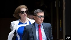 FILE - Former national security adviser Michael Flynn, right, and his lawyer, Sidney Powell, leave the federal courthouse in Washington, June 24, 2019.