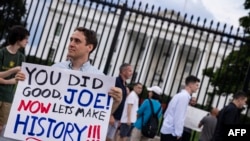 A man holds a sign showing his appreciation for President Joe Biden along Pennsylvania Avenue in front of the White House in Washington, on July 21, 2024.