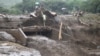 FILE - People cross a bridge broken by heavy rains and landslides in the village of Sebit, West Pokot County, Kenya, Nov. 24, 2019.