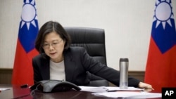 Taiwan's President Tsai Ing-wen speaks with U.S. President-elect Donald Trump through a speaker phone in Taipei, Taiwan. (Taiwan Presidential Office via AP)