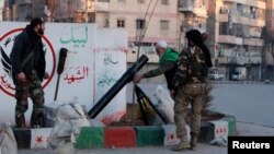 Free Syrian Army fighters prepare to launch a mortar towards fighters from the Islamic State in Iraq and the Levant from a street in the Kadi Askar neighborhood of Aleppo, Jan. 7, 2014. 