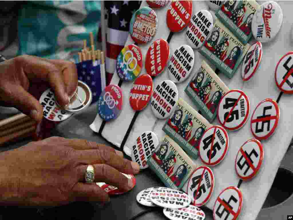 Buttons are for sale at a rally in Freedom Plaza, on the one year anniversary of Charlottesville's Unite the Right rally, Aug. 12, 2018, in Washington. 