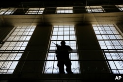 A guard stands watch over death row at San Quentin State Prison in California. A pair of November ballot measures will decide the future of the death penalty in that state.