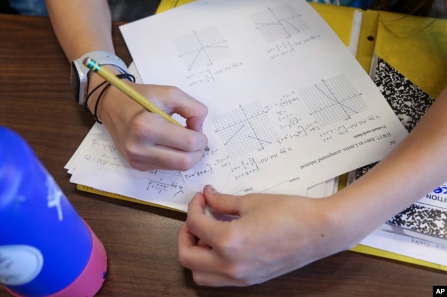 FILE - Boston Latin Academy student Lila Conley, 16, works on a pre-calculus problem during the Bridge to Calculus summer program at Northeastern University in Boston on Tuesday, Aug. 1, 2023. (AP Photo/Reba Saldanha)