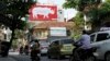 A giant poster, encouraging passers-by to stop using rhino horn, is seen on a street in Hanoi, Sept. 22, 2014. 