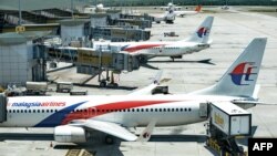 FILE - Malaysia Airlines aircraft are seen at Kuala Lumpur International Airport in Sepang, March 25, 2014.