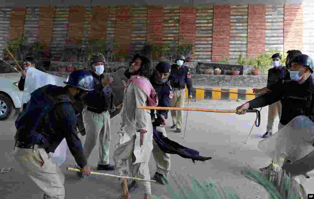 Police officers hit a supporter of Tehreek-e-Labiak Pakistan, a radical Islamist political party, before detaining him at a protest against the arrest of their party leader, Saad Rizvi, in Peshawar.